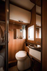 a small bathroom with a toilet and a sink at Camper for 4 persons Istria in Pula
