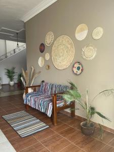 a living room with a couch and plates on the wall at La Casa Guest House in Marsa Alam City