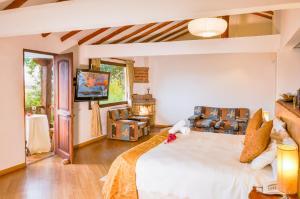 a bedroom with a large bed and a television at Casa de Campo Hotel & Spa in Villa de Leyva +89 photos