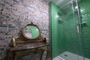 a bathroom with a mirror and a shower at The Angel of Bow in London
