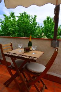 バダロナにあるBarcelona Badalona Playa Terrazaの木製テーブル(椅子2脚付)、ワイン1本