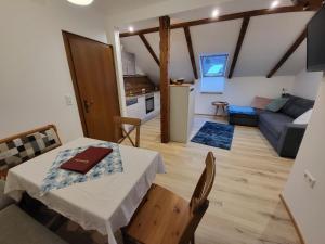 a kitchen and a living room with a table and a couch at Haus Miriam in Sankt Lorenzen ob Murau