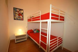 a bedroom with two bunk beds and a lamp at Lets Holidays Apartment Barcelona near beach in Barcelona