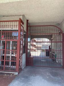 an open gate in a room with a building at Hermoso Depto Centrico in Rancagua