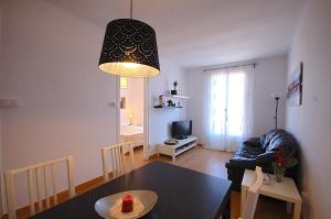a living room with a black table and a dining room at Lets Holidays Apartment Barcelona near beach in Barcelona