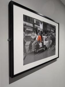 a framed picture of a group of people sitting on a car at Phoenix Pods in Liverpool