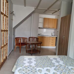 1 dormitorio con mesa y 2 sillas y cocina en Casa Hostal Paso por La Serena, en La Serena