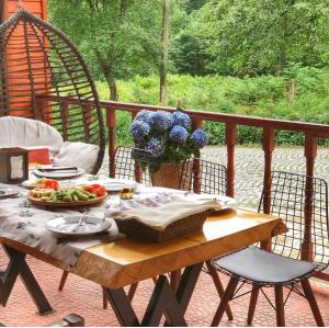a wooden table with a plate of food on a porch at Zilkale Butik Otel in Çamlıhemşin