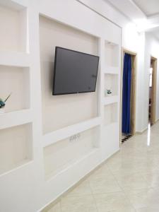 a living room with a flat screen tv on a wall at Your House For Family in Agadir