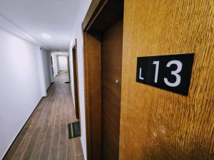 a hallway with a number on the door at Apartman Pahulja - Milmari in Kopaonik +33 photos