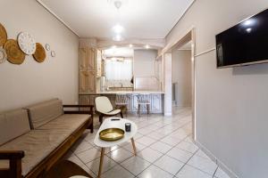 a living room with a couch and a table at Kalamata Old City - Minimal Urban Retreat in Kalamata