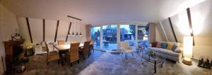 a living room with a table and a dining room at Haus Viking in Brodersby