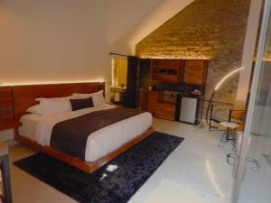 a bedroom with a large bed in a room at Hotel Tila in Cholula