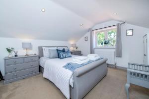 a white bedroom with a bed and a window at Luxury Barn in North Scarle in North Scarle
