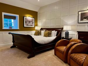 a bedroom with a bed and a couch and a chair at The Wrea Head Hall Country House Hotel & Restaurant in Scarborough