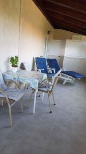 a group of tables and chairs in a room at Apartment in Lopar/Insel Rab 17757 in Lopar