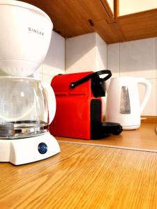 a blender sitting on a counter next to a coffee maker at Lucy's apartment in Athens