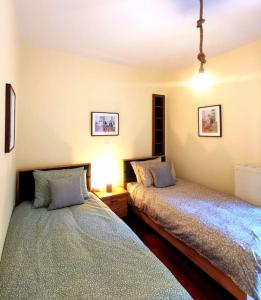 a bedroom with two beds and a lamp at Lucy's apartment in Athens