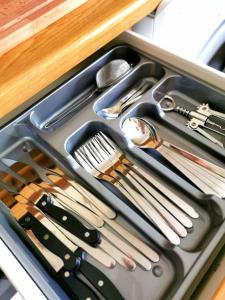 a drawer filled with utensils and utensils at Lucy's apartment in Athens