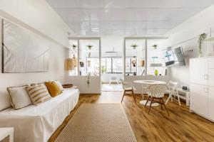 a white living room with a couch and a table at Felicity Accessible Loft-Thessaloniki Superior Apartment in Thessaloniki +27 photos