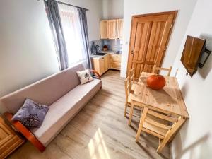 a living room with a couch and a table at Gościniec Smrekowa Chata in Glinka