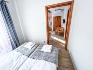 a bedroom with a bed and a hallway with a mirror at Gościniec Smrekowa Chata in Glinka