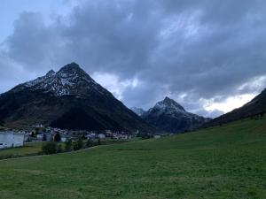 a mountain range with a town in a green field at Chasetta Zum Sigrist in Galtür