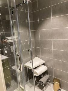 a bathroom with a shower with a glass door at « Le Val d AuRS »Calme et élégance in Strasbourg