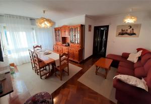 a living room with a red couch and a table at Hospital de Cruces Barakaldo BEC Piso muy luminoso in Barakaldo