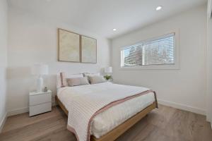 a white bedroom with a bed and a window at Chic and Comfy Home in the Heart of Silicon Valley in Mountain View