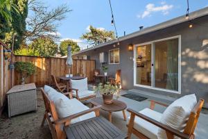 a patio with chairs and a table and a fence at Chic and Comfy Home in the Heart of Silicon Valley in Mountain View
