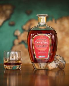 a bottle of whisky next to a glass on a table at chez SAM in Grand-Bourg +16 photos