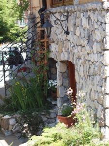 a stone house with a stone wall and a staircase at Willa Bystry, Pod Nosalem in Zakopane