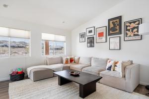 a living room with a couch and a table at Friends and Family! Desert Oasis 3 Mi to Joshua Tree in Yucca Valley