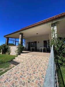a house with a stone walkway in front of it at Agriturismo Graziano e Barbara in Porto Conte