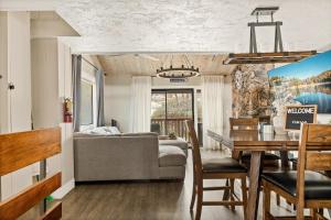 a living room and dining room with a couch and a table at First Class Location in Big Bear Lake