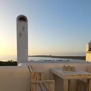 a table and chairs on a balcony with a view of the ocean at CVista in Jacobs Bay