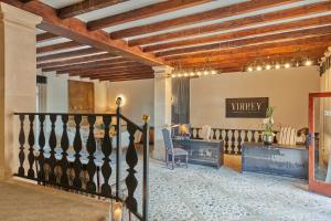 eine Lobby mit einer Treppe und einem Tisch mit einem Stuhl in der Unterkunft Virrey Finca Hotel in Inca