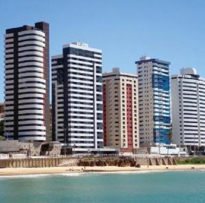 a group of tall buildings in a city at Seu lugar em Natal in Natal