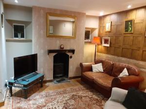 a living room with a couch and a fireplace at Characterful Cottage near the Sea, Beach, Pier & Shops in Weston-super-Mare