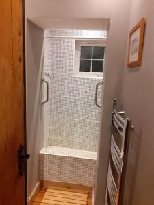 a bathroom with a walk in shower next to a window at Characterful Cottage near the Sea, Beach, Pier & Shops in Weston-super-Mare