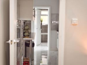 a room with a hallway with white walls and a door at *Sleeps 9* Modern, 4 Bed House, Birmingham in Birmingham