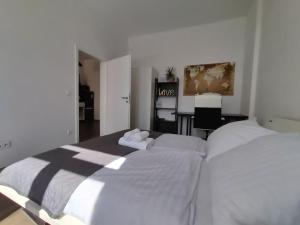 a bedroom with two beds with white sheets at Apartment Voria in Hamm