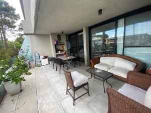 a patio with a couch and chairs and a table at Exclusivo y elegante! in Montevideo