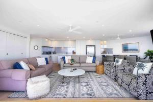 a living room with a couch and a table in it at Bay View in Tweed Heads