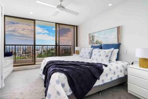 a bedroom with a bed and a large window at Bay View in Tweed Heads