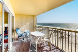 a balcony with a table and chairs and the ocean at Driftwood Towers 4H in Gulf Shores