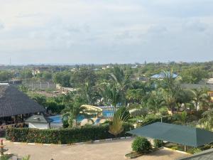 a view of a resort with a pool and palm trees at Villa Duran - 5 bedrooms in Ukunda