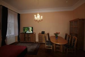 a living room with a dining room table and a chandelier at Apartment No 0B Petrinska 18 - Mala Strana in Prague