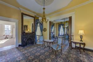 a living room with a fireplace and a table and chairs at The Inn at Cedar Grove in Vicksburg +96 photos